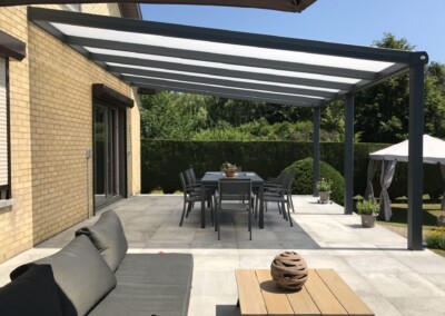 Très grande pergola moderne qui couvre une table et des chaises de jardin