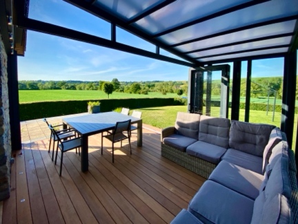 Retractable patio cover with table and sofa